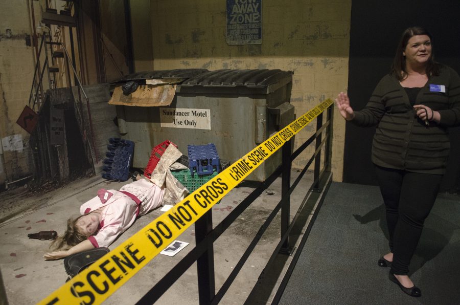 Brook Breitsprecher, the Putnam’s digital media and design coordinator, describes one of the three crime scenes in the museum’s newest exhibit, ‘CSI: The Experience,’ in which a female waitress appears to have been run over. The exhibit opened on March 1.
Photo by Kyle Soyer.