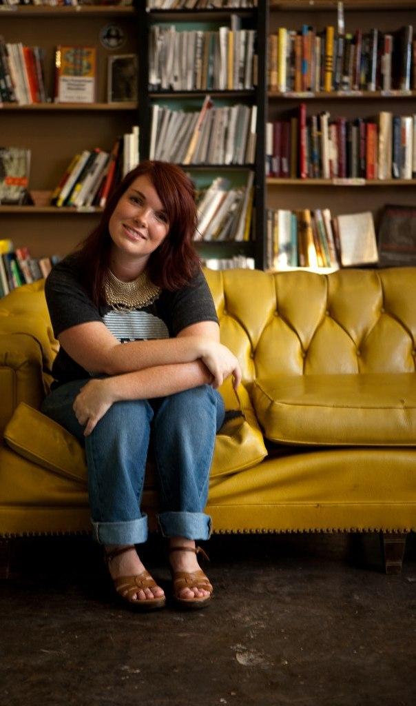 Poet Lauren Zuniga poses on a yellow couch for Oklahoma Magazine.   Photo courtesy of Lauren Zuniga. 