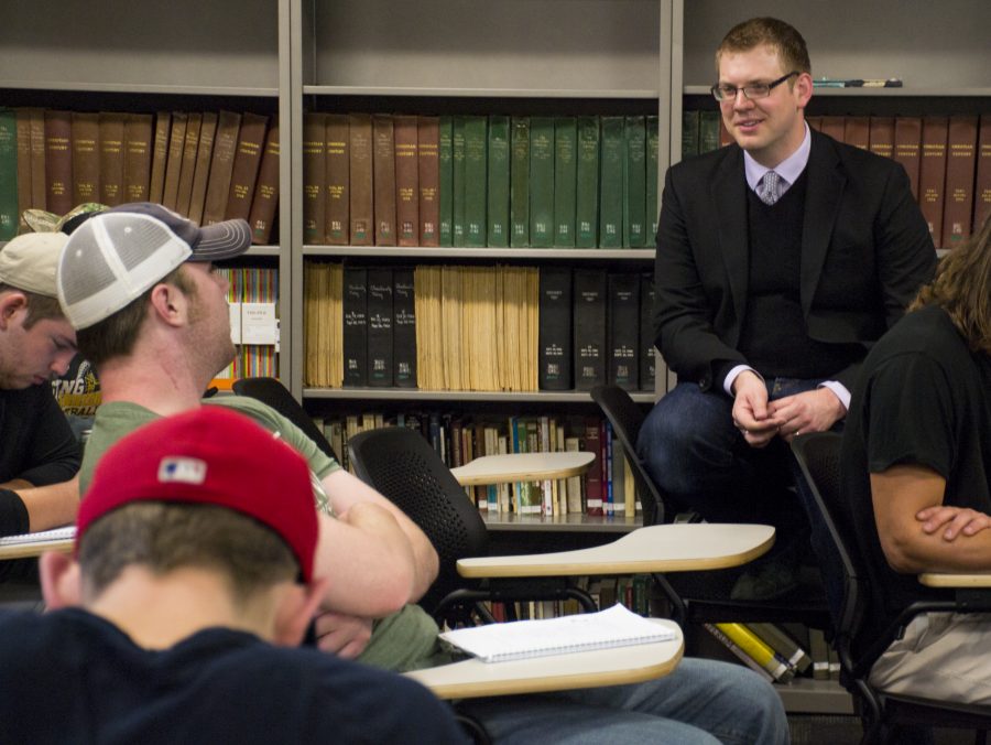 Professor Brian Leech (right) discusses the Great Society with a student group during his HIST-132 class.
Photo by Cam Best.