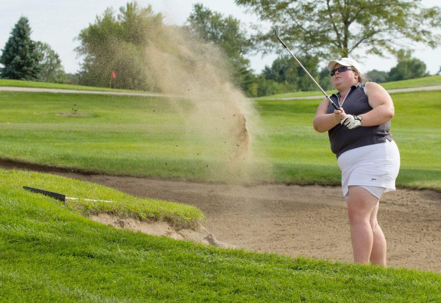 Junior Samantha Barlage chips a ball out of the sand trap and onto the green. Barlage’s average score of 88.5 is leading the team as they go into the CCIW tournament Oct. 2 through 4.
Photo by Andrew Skalak.