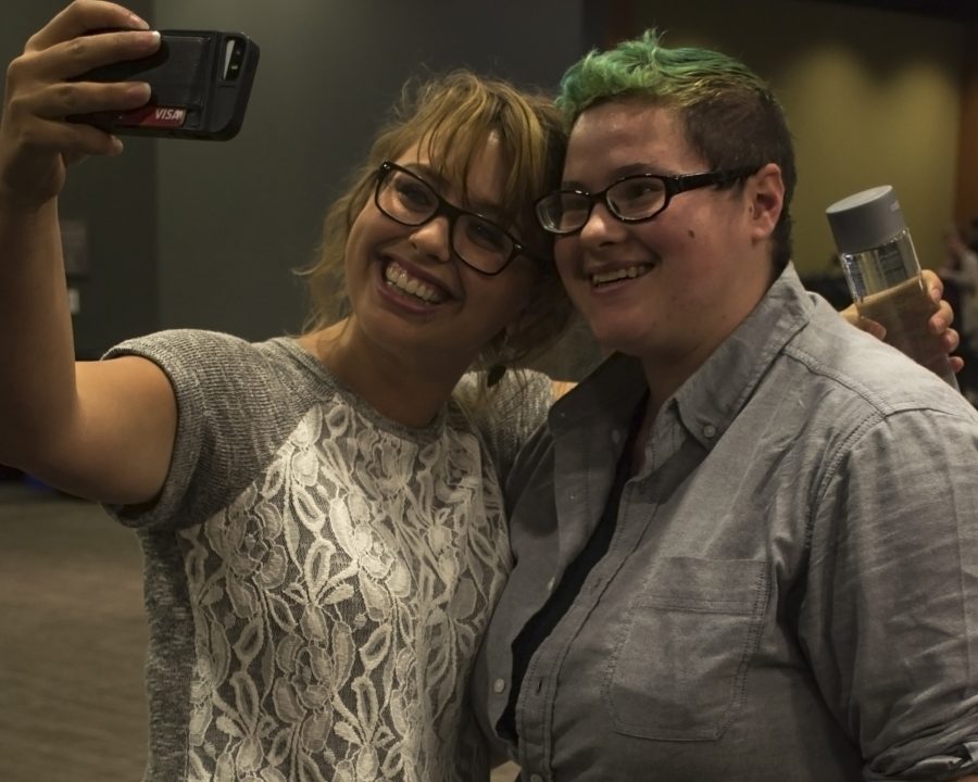 Speaker Laci Green, holds out her phone to take a selfie with AugieEquality member Hanna Anderson.