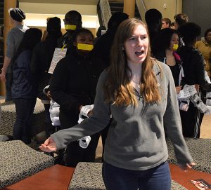 Junior Eleanor Nolan shouts out during the group's demonstration in Old Main. Photo by Ryan Silvola.