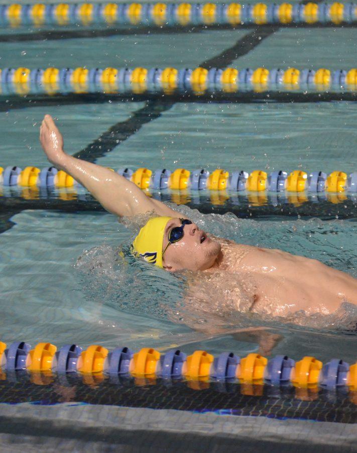Senior+Aaron+Holt+swims+the+backstroke+at+practice+Dec.+16.+Holt+is+the+team+captain.%0APhoto+by+Ian+Magnuson.