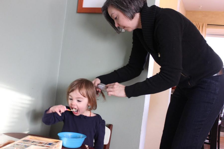 Jennifer Popple brushes her daughter, Anya’s hair while eating breakfast and getting ready for school. Popple has two children with Samantha Keehn, a professor in the music department.
Photo by Madison Rodgers.