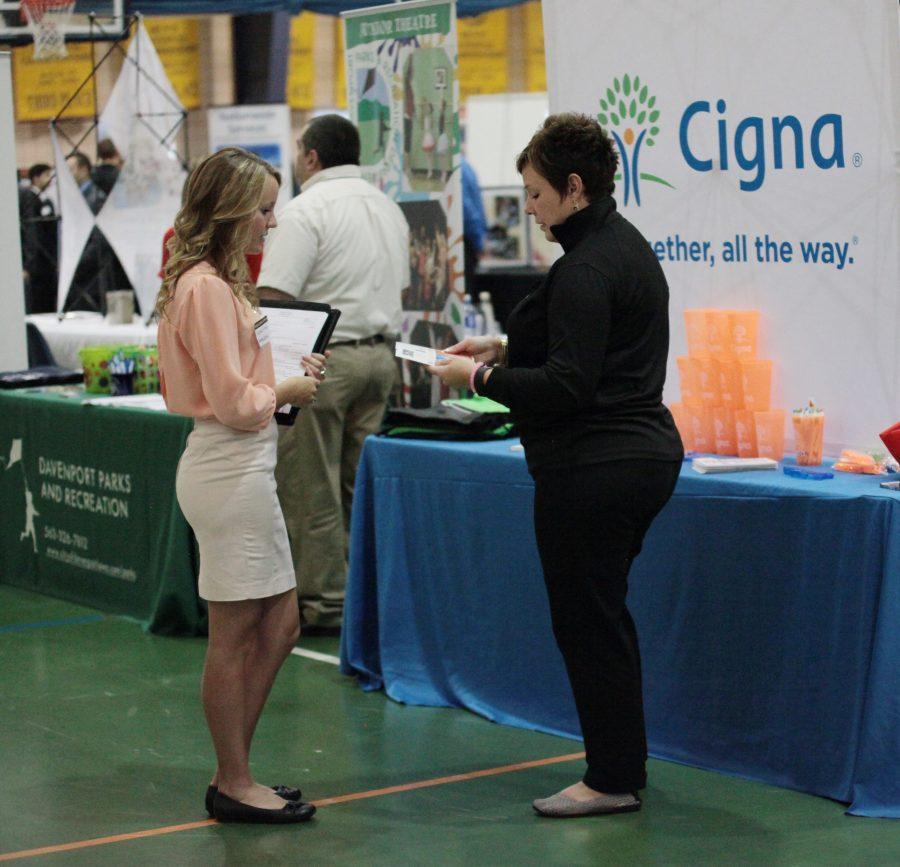 Junior Sarah Funke talks to a representative from Cigna Health Insurance, an insurance agency based in Cameron, Ill. at ProFair on Sept. 22 in the PepsiCo Recration Center. Over 87 professional organizations were represented, offering internships and employment opportunities. Follow-up interviews took place on Sept. 23 at St. Ambrose University.
Photo by LuAnna Gerdemann.