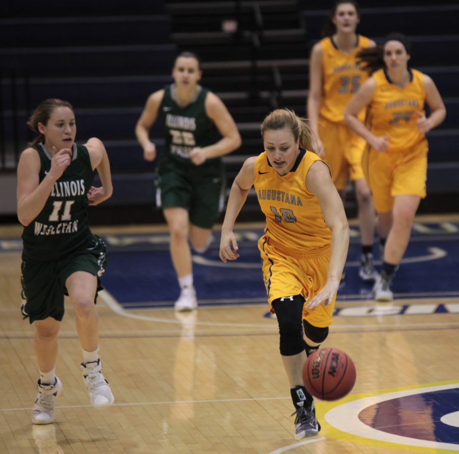 Izzy Anderson takes control of the ball and runs it down the court. Photo by LuAnna Gerdemann. 