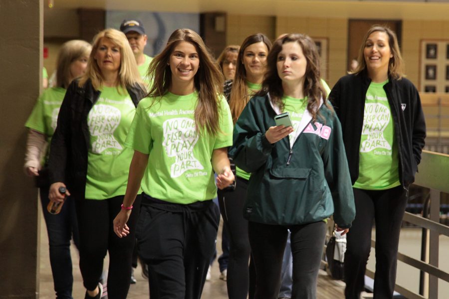 Delta Chi Theta sorority members and their families walk around the balcony of the gym for the Mental Health Awareness Walk. Photo by LuAnna Gerdemann.