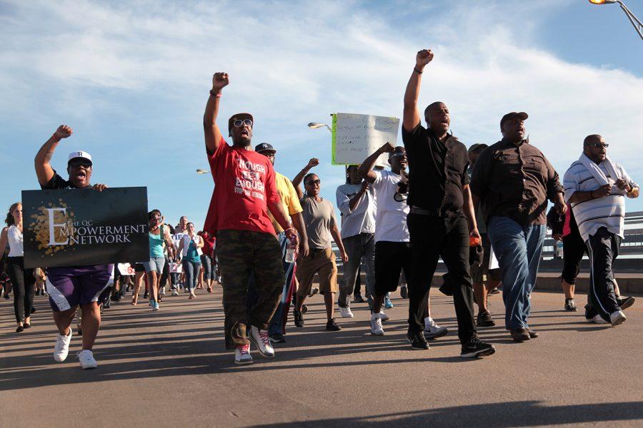 The leaders of the march chant, “Take it down!” as they cross Centennial Bridge. Photo by LuAnna Gerdemann.