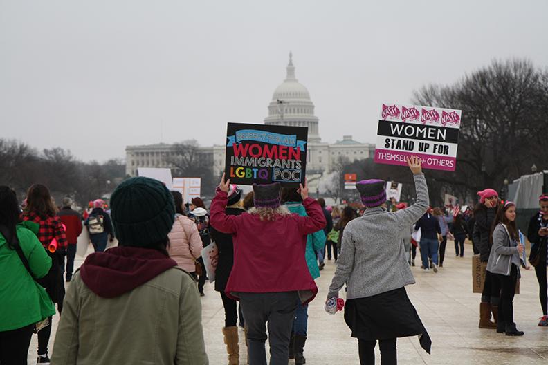 Women+raise+their+signs+high+in+the+air+as+they+march+towards+the+Capitol+Building+to+get+to+the+Womens+March+in+Washington+D.C.+Photo+by+Alia+McMurray.