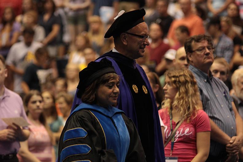 President Steven Bahls and Provost Pareena Lawrence head towards the stage in Carver during the 2015 Welcome Week Opening Convocation. Photo courtesy of Observer photo files.