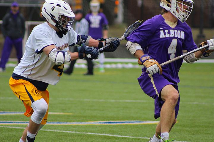 Sophomore Jason Van Dyck defends Albion senior Zach Ubbell during their game on Saturday, March 25. Vikings fell to Albion 5-13. Photo by Alia McMurray.