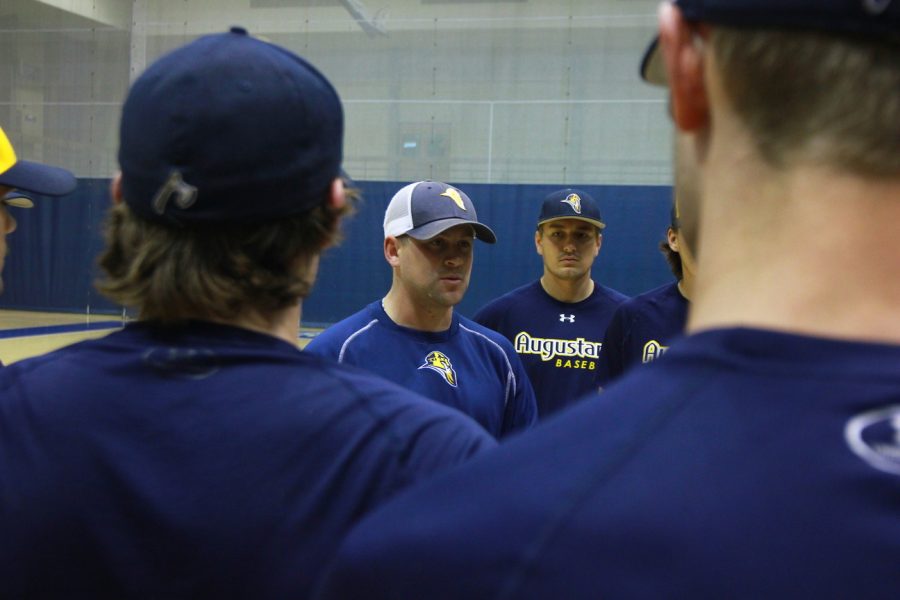 Pitching coach Justin Hauer meets with Augustana baseball players during practice. The Vikings will play two CCIW opponents this weekend. 