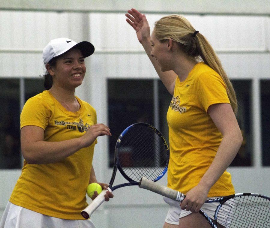 Sophomore Madeline Lombardi and Senior Lauren Goggin (left to right) congratulate each other after a match during the AQ Tournament last Saturday. Photo by Kevin Donovan.