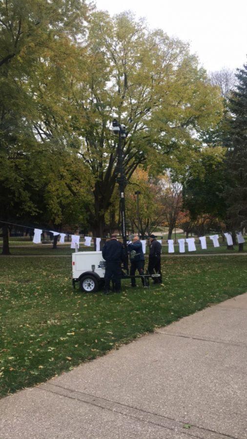 Augustana Public Safety installs security cameras on the premises near the Clothesline Project in the lower quad. Photo by Lu Gerdemann.