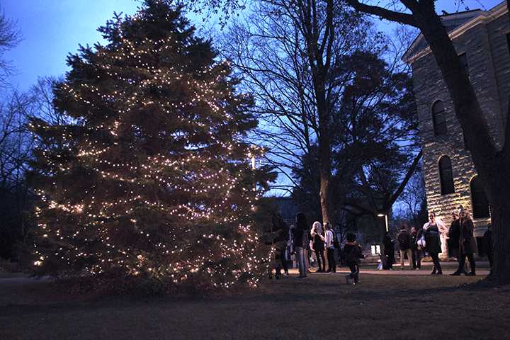 Student, faculty, and family gather around the Christmas tree outside of Old Main after its annual lighting on Wednesday. Photo by Kevin Donovan