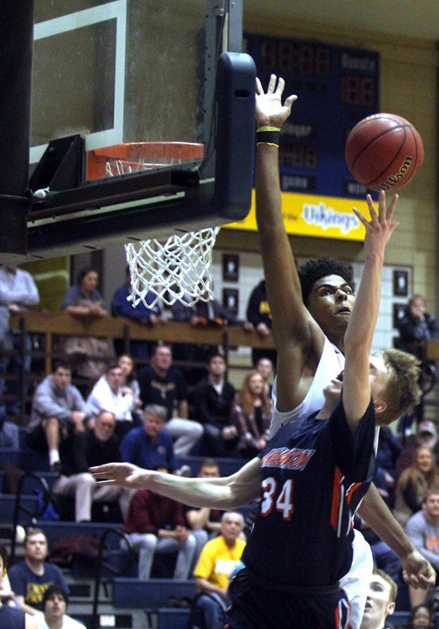 Micah Martin, sophomore, blocks Luke Peters, junior from Wheaton College, attempting to score. Photo by Collin Schopp. 
