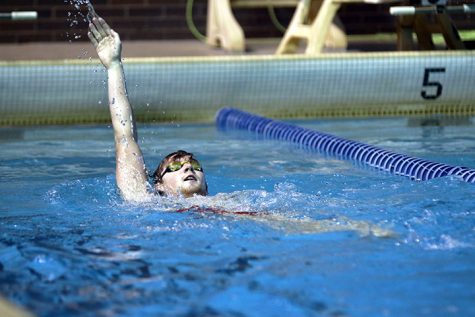 Sophomore Connor Bullard swims backstroke at practice to train for the teams meet against Wheaton on February 3. Photo by Tony Dzik.
