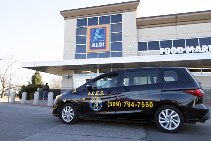 ACES driver Amy Green (20) waits outside of Aldi during an ACES special event that transports students to Aldi from campus. Photo by Kevin Donovan
