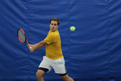 Senior Eric Pohl returns the serve from Illinois Tech. Augustana won with a score of 9-0.
