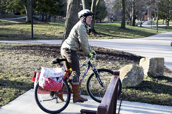 Jane Simonsen, professor of history and gender studies, is arriving to work on her bicycle. Simonsen will ride to work all the time unless ice gets in her way. Photo by Brady Johnson.
