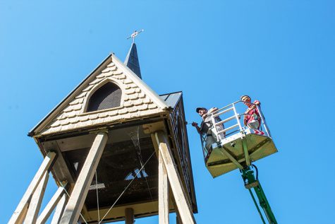 Doug Stevens and Ian Erickson of Creative Decorating Inc. paint the belltower.