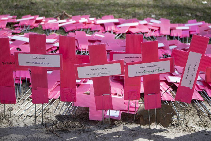 Augustanas pro-life club demonstrates in partnership with Illinois Students for Life of America on Monday, April 1. The posters show statistics from Planned Parenthood, gathered from the annual 2017-2018 Planned Parenthood report. Photo by Emily Jacobson.