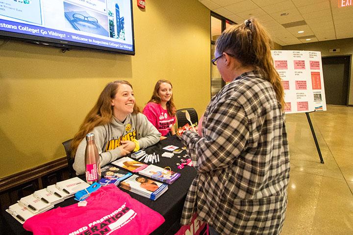 Augustana Junior Sage Sanders (from left) and First-year Aubrey Lathrop talk with Senior Lily Tewksbury at the Generation Action at Augustana table in the Gerber Center Brew, October 18, 2019. The table was set up as a counter protest to the showing of “Unplanned” by the Augustana Students for Life that would show later that evening in Hanson 304.