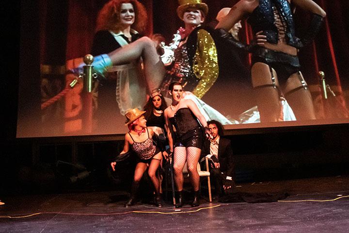 Augustana sophomore Mary Sales (from left), juniors Cassie Karn and James wheeler and senior Jonathan Quigley pose at Frank N’ Furter’s throne during The Rocky Horror Picture Show Shadowcast at the Augustana College Brunner Theater Center on October 24, 2019.