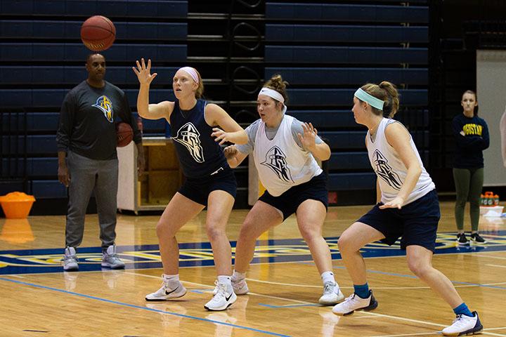 Augustana sophomore Olivia Hagerty, sophomore Cassie Kruse, and senior Jeni Crain practice their team drill during during the womens basketball practice in Carver on November 4, 2019.