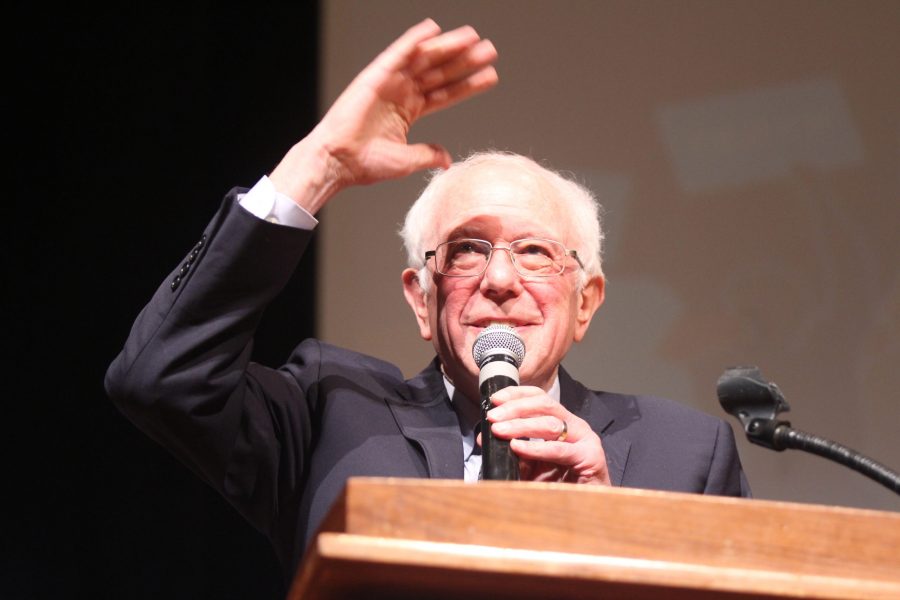 Senator Bernie Sanders waves to the crowd before speaking after being welcomed on stage during the presidential candidate forum through The Peoples Caucus on Sunday, January 12 at Davenport North High School. Photo by Kevin Donovan