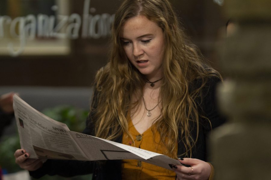Senior Brandy Mathews reads from a copy of The Observer during a student meeting to discuss what students want to change in regards to the Phi Omega Phi fraternity on Thursday, Feb. 20. Photo by Kevin Donovan