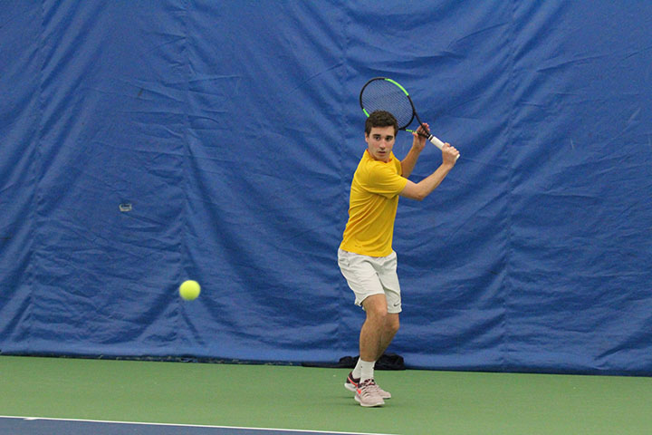 Sophomore Leonardo Panosso keeps his eye on the ball during his match against Coe at the Quad Cities Tennis Club on February 15th, 2020. The Vikings lost the match 4-5.