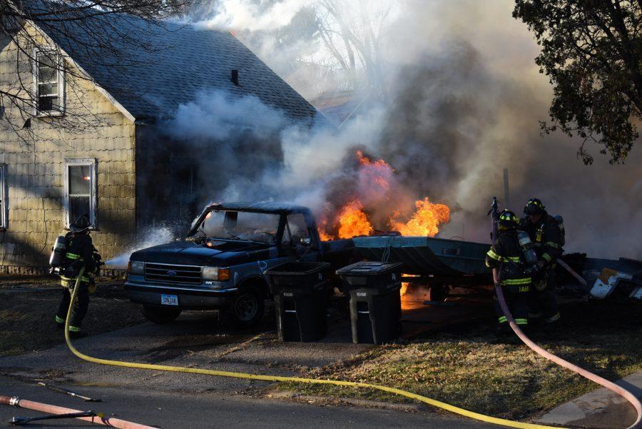 Firefighters rush in to put out the truck on fire on the northeast corner of 35th Street and 12th Avenue on Sunday, March 8, 2020. Photo by Christopher Ferman