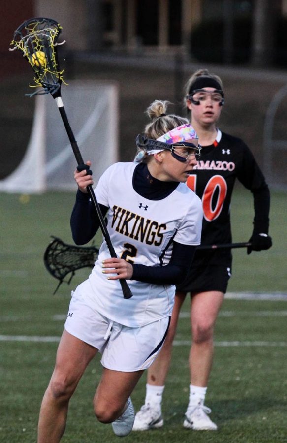 Junior Sandra Pielechaty keeps a focused eye down the field with Jordan Reichenbach trailing behind her during the women’s lacrosse match against Kalamazoo at the Thorson-Lucken Field on February 29, 2020. The Vikings lost the game 17-7. 