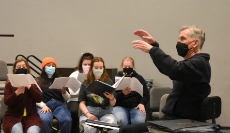 Jon Hurty conducts students during choir practice in Larson Hall.
