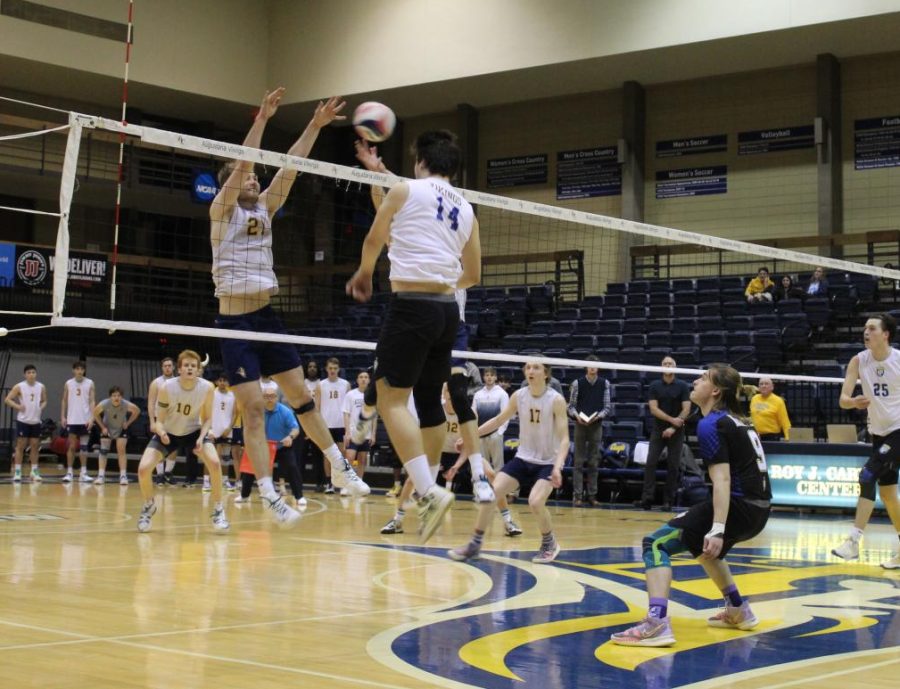 Junior right side hitter Josh Van Essen and sophomore middle blocker Ben Schultz block another one of the opposing teams balls on March 30 at the Carver Center.