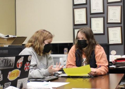 Co-Editor-in-chief Olivia Doak listens to Managing Editor Carly Davis idea for the graphic design on March 14 at Old Main.
