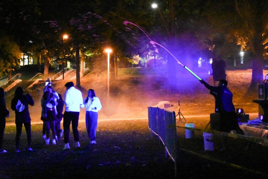 Workers drench Augie students in glow paint at the EDM Glow Party on Friday, Oct 21 2022.