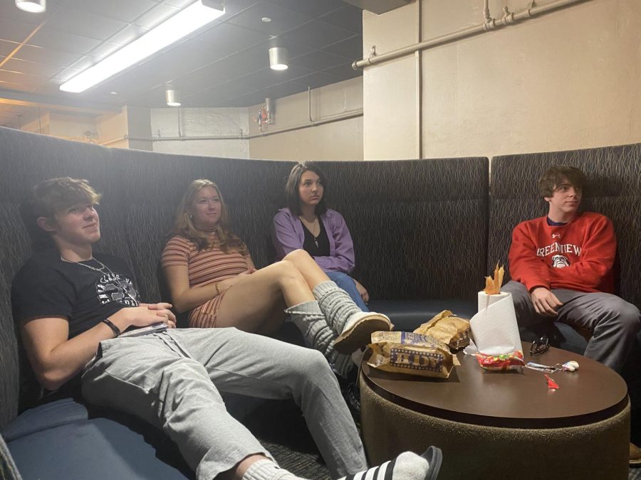  Freshmen Josiah Hull, Olivia Steele, Catie Karn and Cam Tomko watching a movie in the Andreen lower lobby.