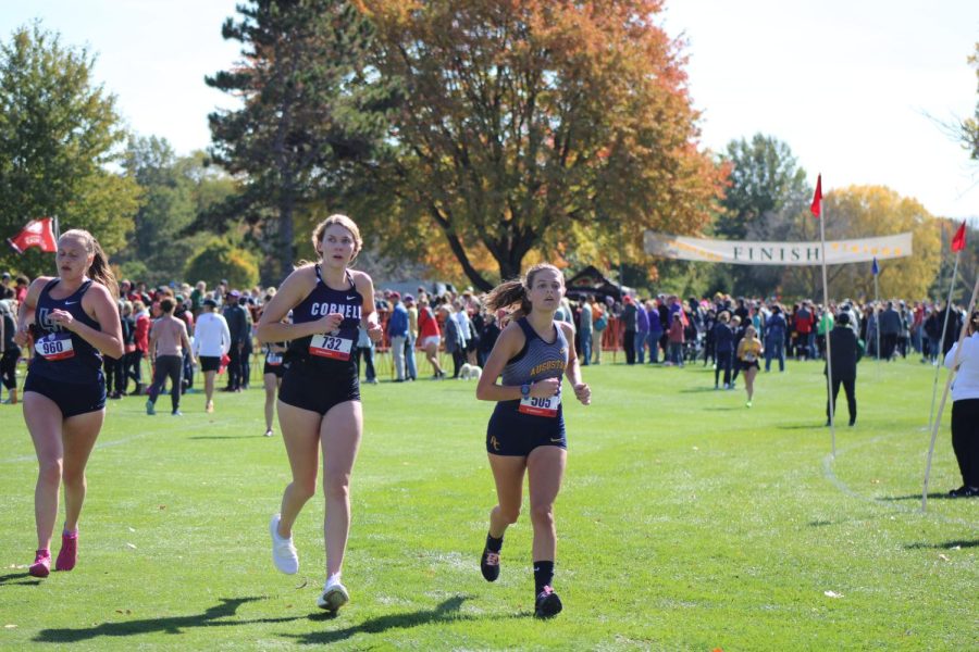 Emma Gocken, sophomore, runs with a Cornell runner on 10/15/22.