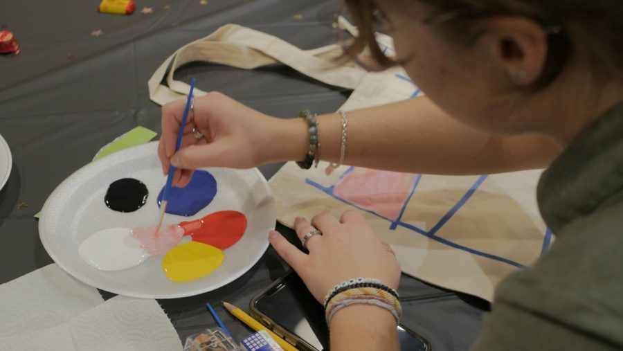Event participants create different designs for their own tote bag.
