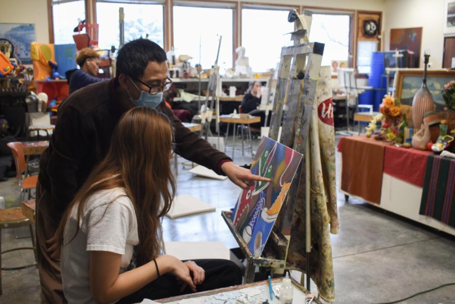 Peter Xiao speaks with a student during a painting class in Abbey Studios.
