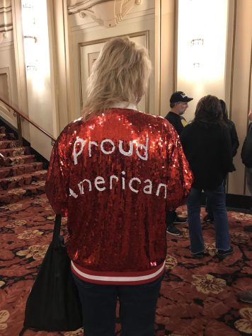 Sandy Ejupi, Trump supporter from the Chicagoland area, wears a jacket that reads Proud American at the Adler Theatre.