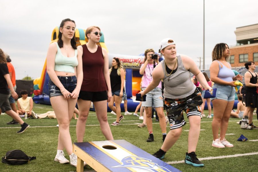 First years Bri Clark, left, Diana Dethloff, center, and Carrie Uddenberg, right play a game of bean bag toss during Sloughfest at Augustana College on May 6, 2023.