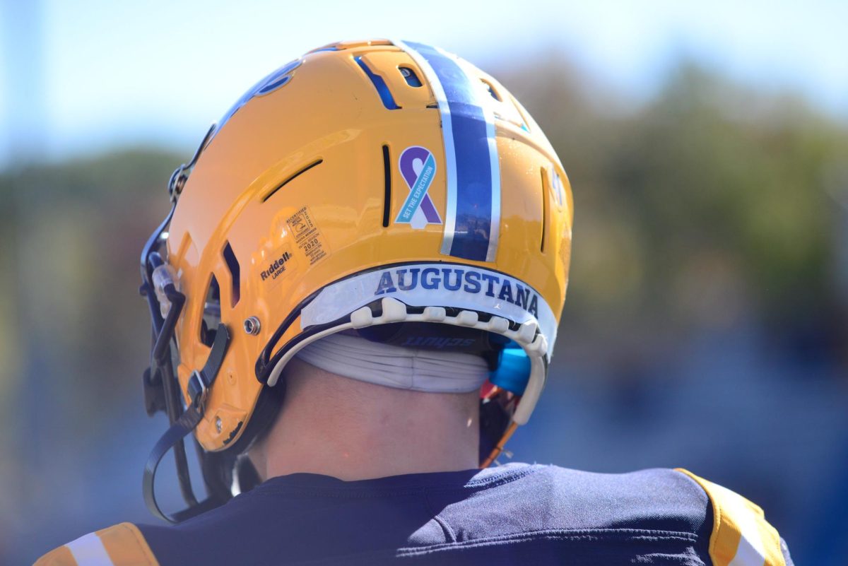 Augustana College’s men’s football team wore purple and blue ribbon stickers on their helmets as a sign of solidarity for victims of gender-based violence and abuse during the second annual “Set The Expectation” game against North Park, on Oct. 21. 