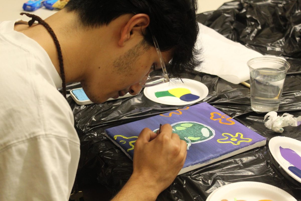 Junior Arnav Shrestha paints during the Paint with Da Guys event, hosted by the Multicultural Men’s Association on Sept. 28.
