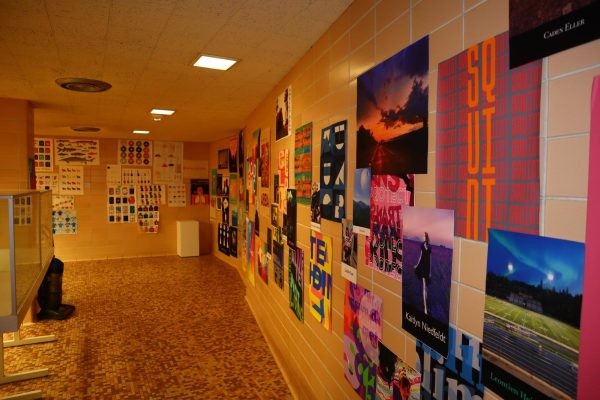 Artworks and posters by the students of Augustana College fill up the walls of what was once a bathroom at the Bergendoff Museum.