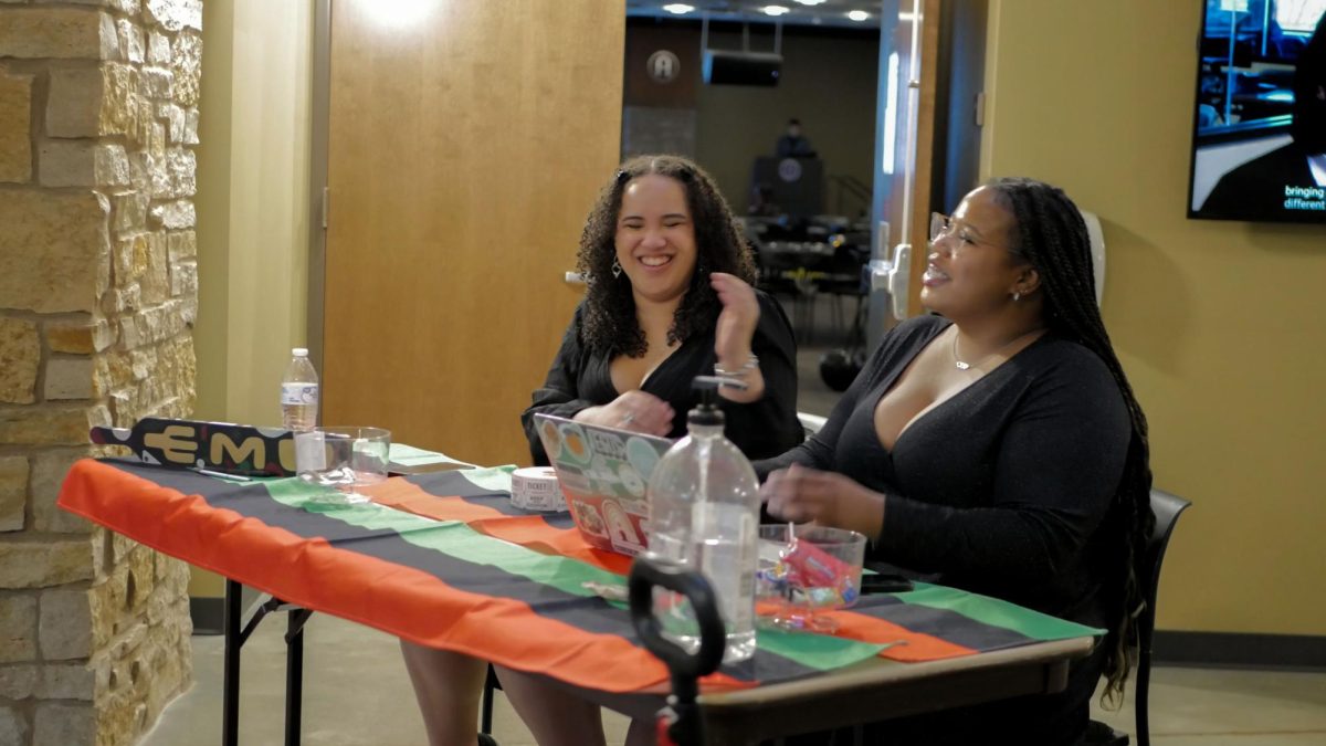 Sophomore Reigna Hels, secretary of the Black Student Union, shares a laugh with Cloman while waiting for attendees.