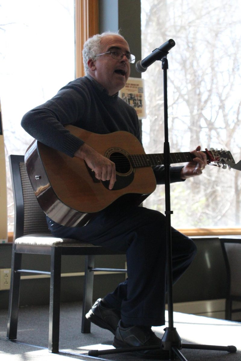 Professor of Education Mike Egan sings “Redemption Sing” by Bob Marley during the African American Read-In event held at the Brew on Feb 29, 2024.