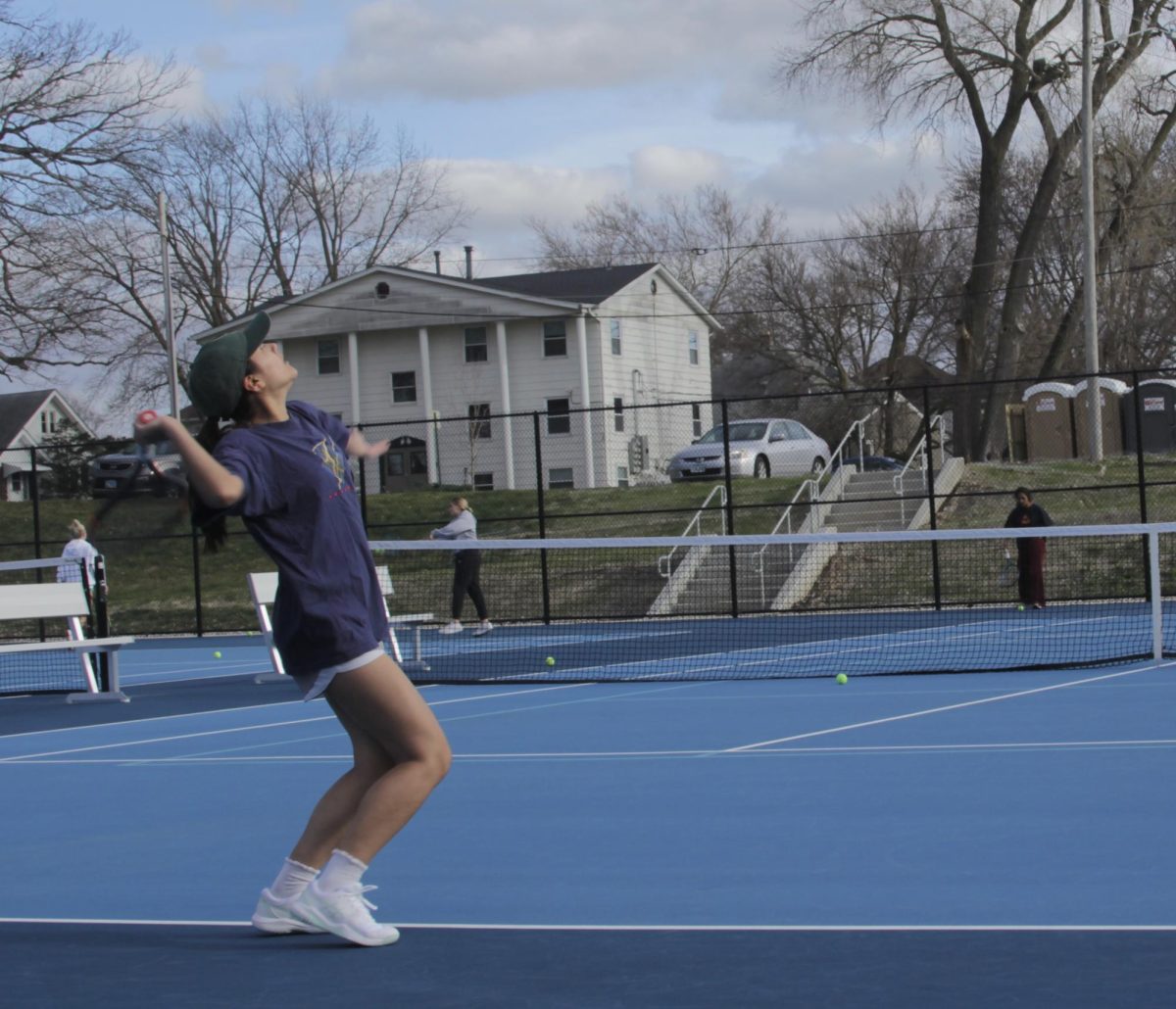 Augustana College women’s tennis team practices on the new Lincoln Park Tennis Court near Swanson, equipped with benches.
